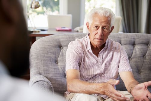 Senior man talking to counsellor 